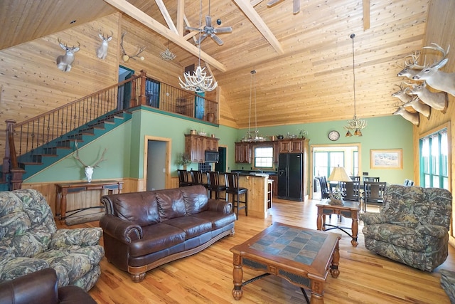 living room with beamed ceiling, light wood-type flooring, high vaulted ceiling, and wooden ceiling