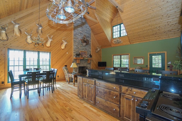 kitchen featuring a fireplace, high vaulted ceiling, and a wealth of natural light