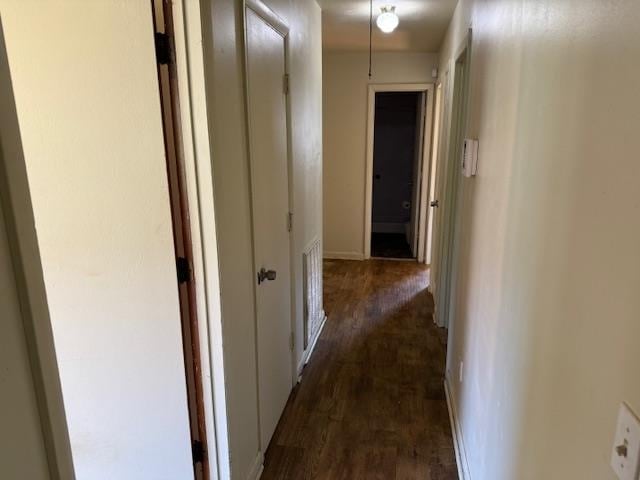 corridor featuring dark hardwood / wood-style flooring