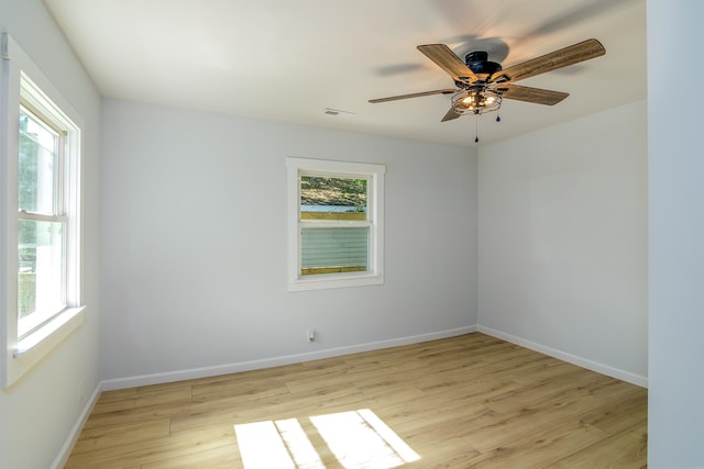 empty room featuring ceiling fan and light hardwood / wood-style flooring