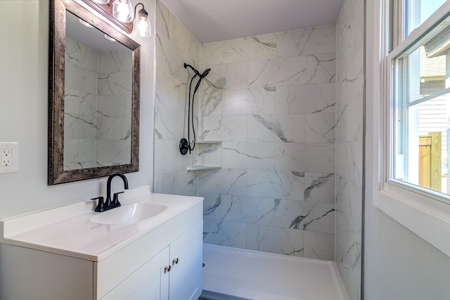 bathroom with vanity and a tile shower