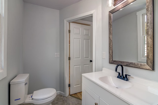 bathroom with vanity, toilet, and tile patterned floors