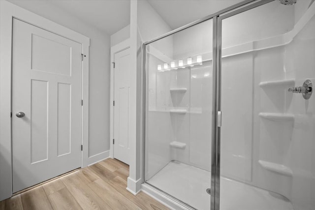 bathroom featuring an enclosed shower and hardwood / wood-style floors