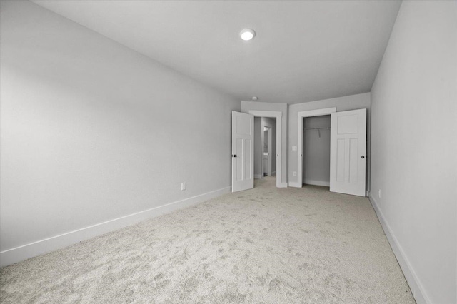 unfurnished bedroom with carpet and a closet