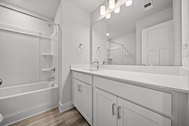 bathroom featuring shower / bathing tub combination, vanity, and hardwood / wood-style floors