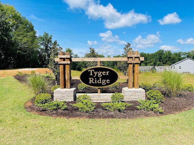 community / neighborhood sign with a lawn