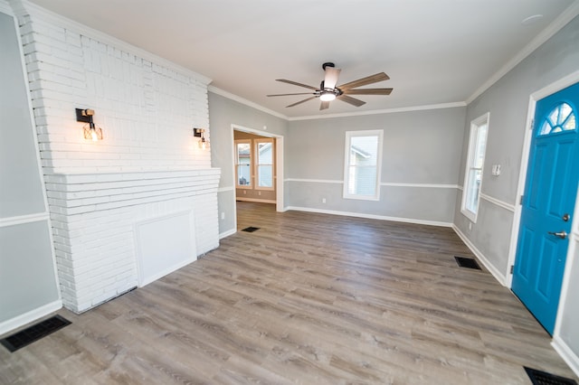 foyer with crown molding, ceiling fan, and wood-type flooring