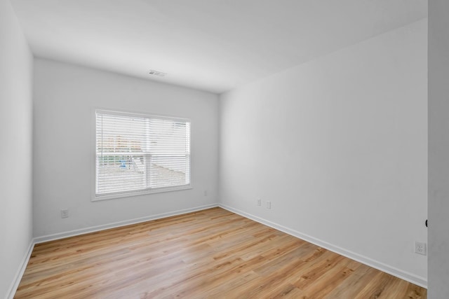 empty room with light hardwood / wood-style flooring