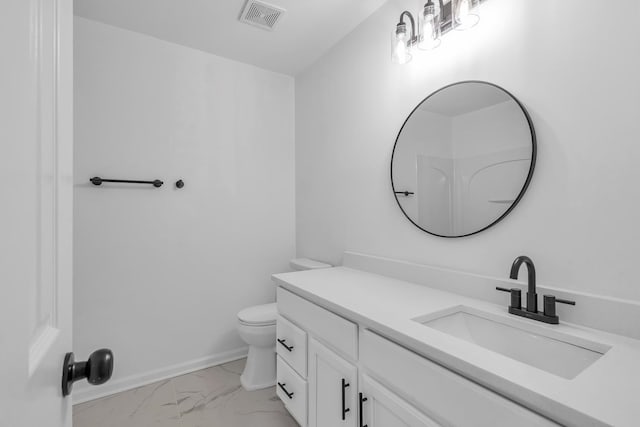 bathroom featuring vanity and toilet