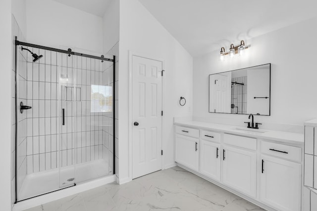 bathroom featuring vanity, vaulted ceiling, and a shower with door