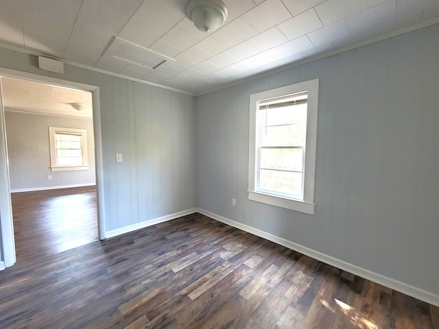 spare room featuring crown molding and dark hardwood / wood-style flooring