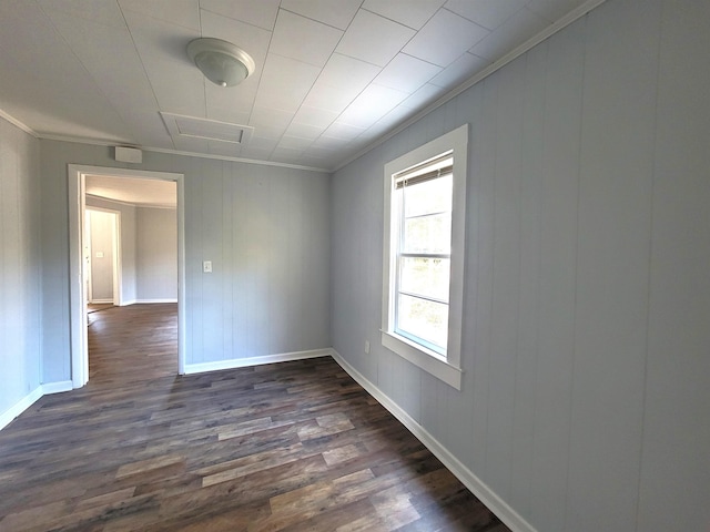 spare room with crown molding and dark hardwood / wood-style flooring