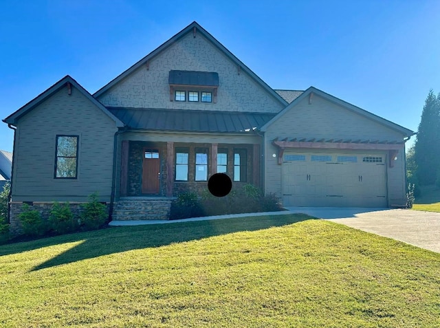 view of front of house featuring a garage and a front lawn