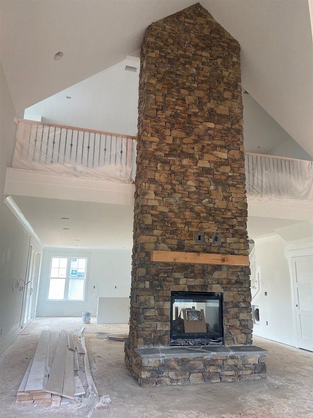 unfurnished living room featuring a fireplace and high vaulted ceiling