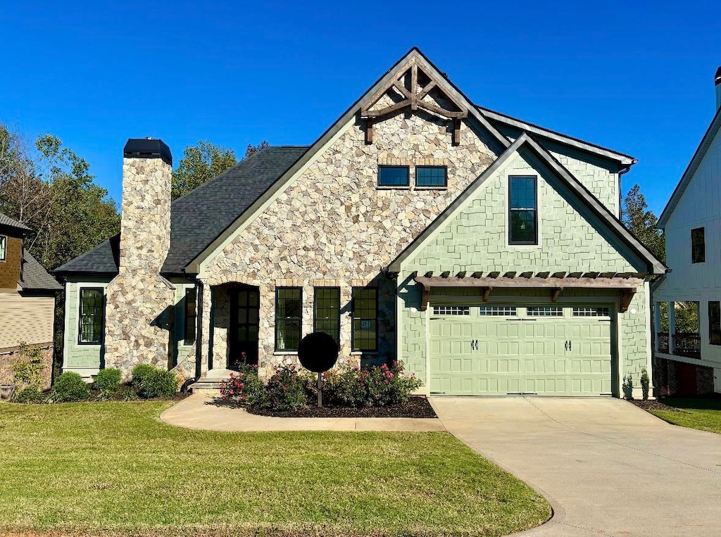 view of front of home with a garage and a front lawn