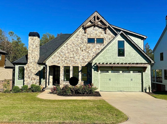 view of front of home with a garage and a front lawn