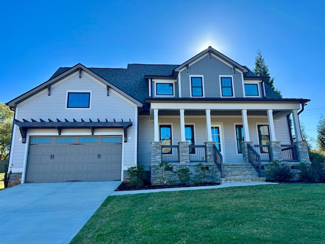 craftsman-style home with a garage, a porch, and a front lawn