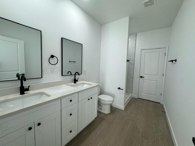 bathroom with vanity, hardwood / wood-style flooring, and toilet