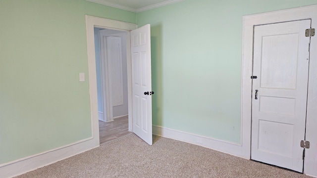 unfurnished bedroom featuring ornamental molding and light colored carpet