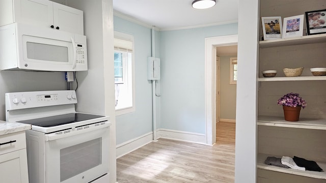 kitchen featuring white appliances, crown molding, white cabinets, and light hardwood / wood-style flooring