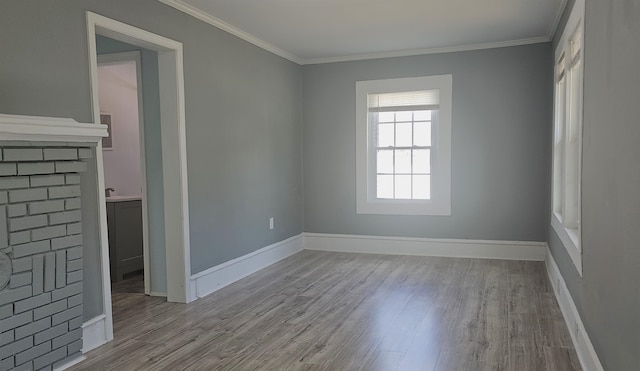 unfurnished room with ornamental molding and light hardwood / wood-style flooring