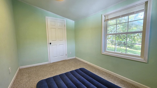 bedroom with lofted ceiling, ornamental molding, and carpet