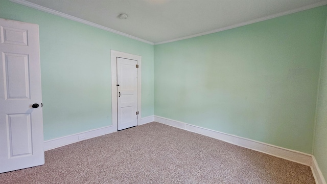 unfurnished room with crown molding and carpet flooring