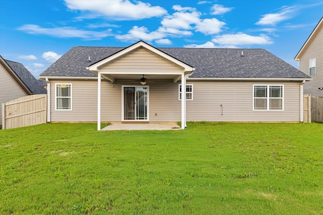 back of property featuring ceiling fan, a lawn, and a patio