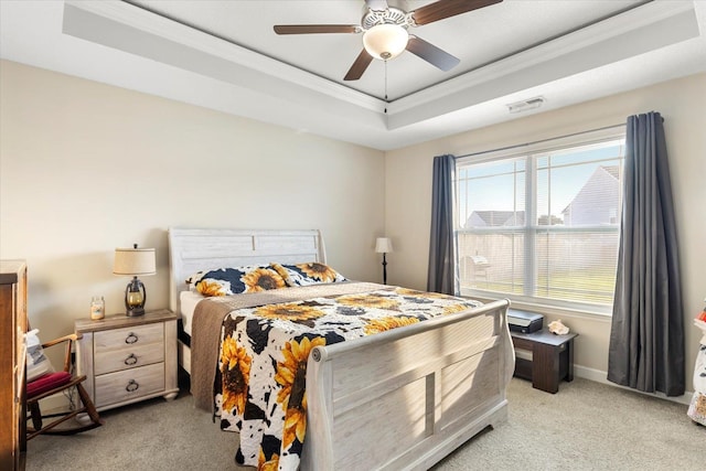 bedroom featuring ceiling fan, light colored carpet, a raised ceiling, and crown molding