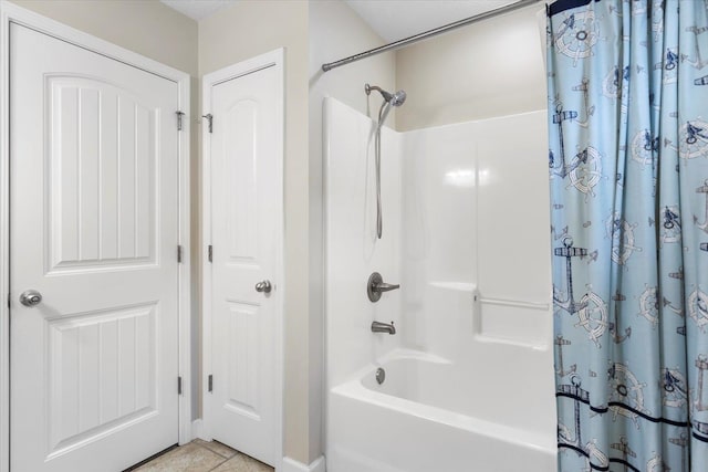 bathroom with tile patterned floors and shower / bath combo