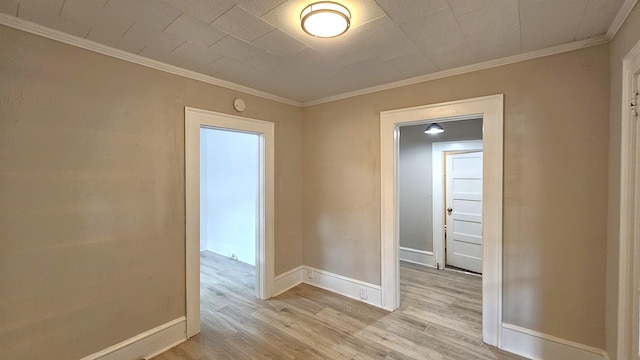 unfurnished room featuring ornamental molding and light hardwood / wood-style floors