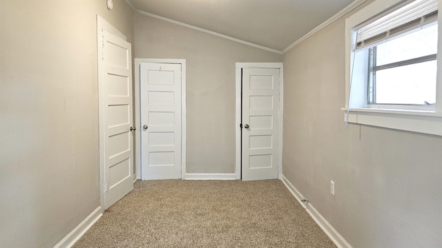 hallway featuring carpet floors, crown molding, and vaulted ceiling