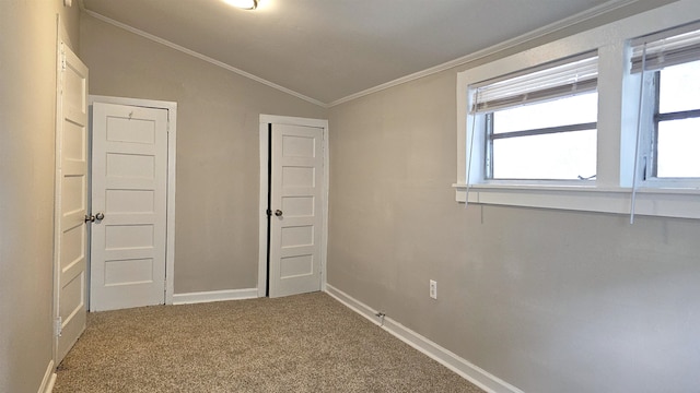 unfurnished bedroom with lofted ceiling, ornamental molding, and carpet flooring