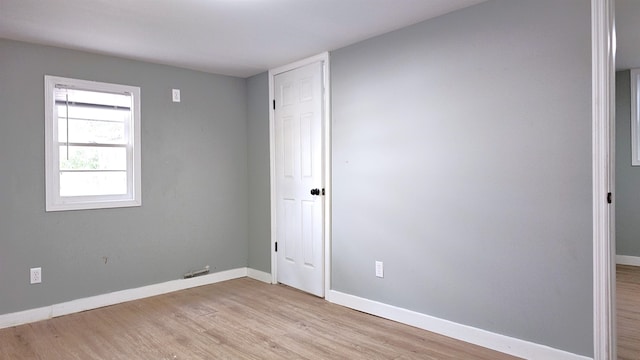 spare room with light wood-type flooring