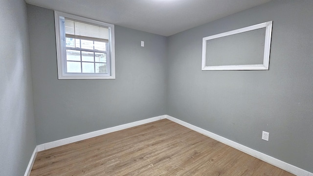 empty room with light hardwood / wood-style flooring