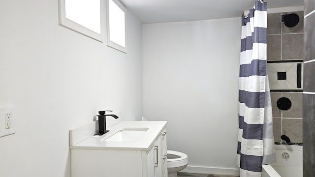 full bathroom featuring vanity, shower / tub combo with curtain, and toilet