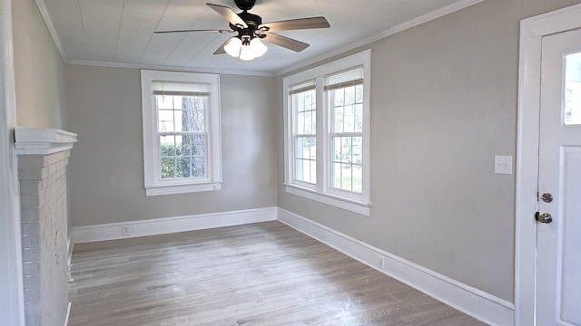 unfurnished living room featuring ornamental molding, plenty of natural light, and light hardwood / wood-style floors