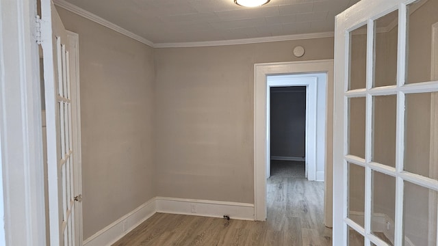 unfurnished room featuring hardwood / wood-style flooring and ornamental molding