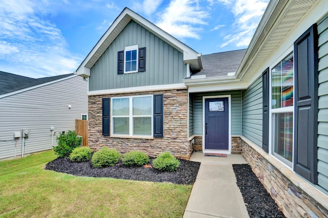 entrance to property with a lawn