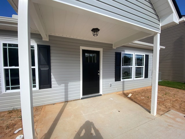 property entrance featuring a patio area