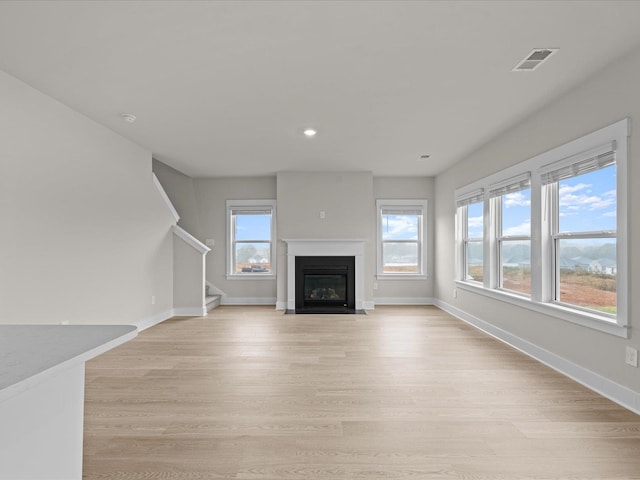 unfurnished living room with light hardwood / wood-style flooring