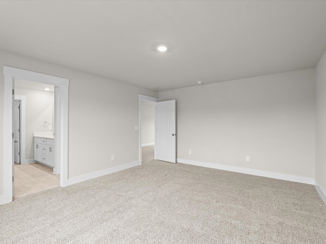 unfurnished room with light colored carpet