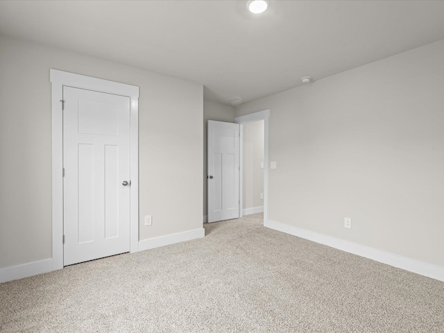 unfurnished bedroom featuring light colored carpet