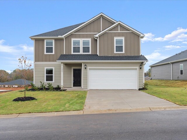 view of front of property featuring a garage and a front yard