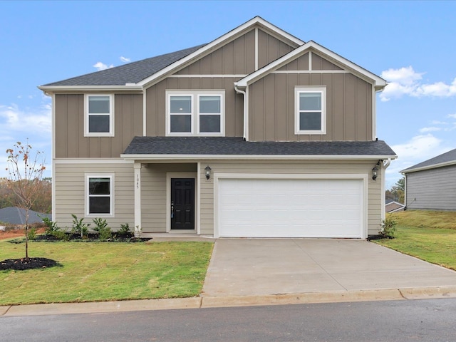 view of front of property featuring a garage and a front yard