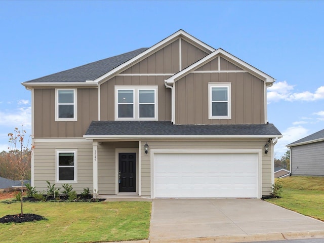 view of front of property featuring a front yard and a garage