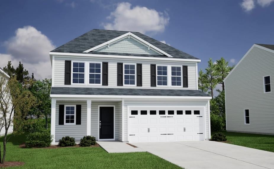 view of front facade with a garage and a front yard