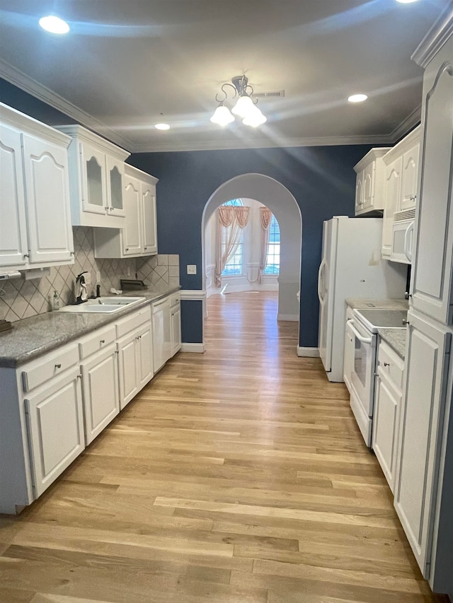 kitchen featuring crown molding, sink, light wood-type flooring, white cabinetry, and white appliances