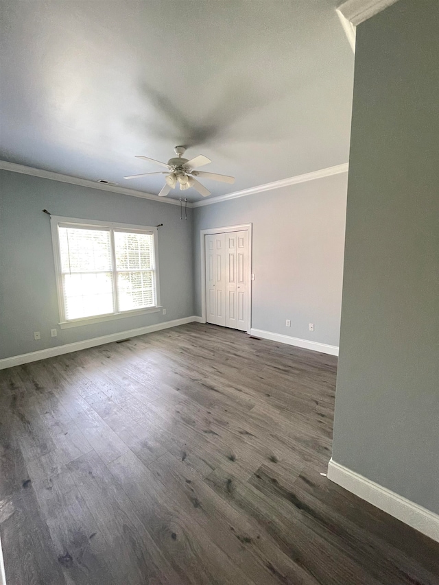 unfurnished room featuring ceiling fan, ornamental molding, and dark hardwood / wood-style floors