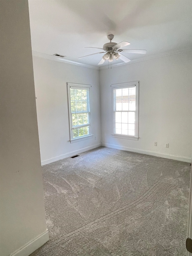 carpeted empty room with ceiling fan and ornamental molding